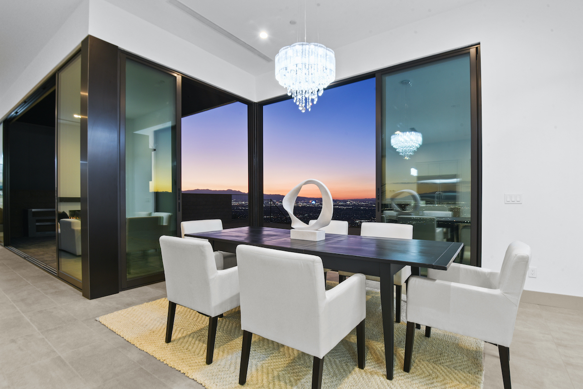 Summerlin staged home features an elegant dining area with sunset vistas. | Utopia Luxury Home Staging & Design