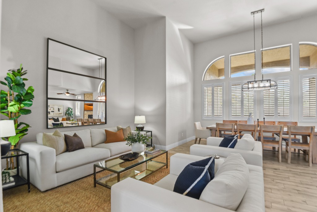 Staged home with two-story ceilings showing psychological impact of furniture arrangement