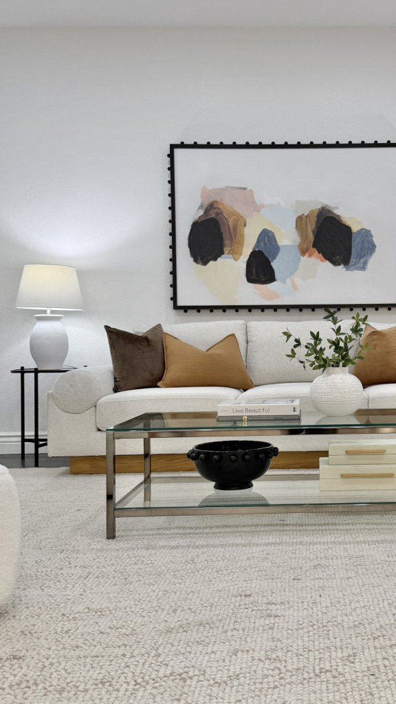 How Staging ROI Changes in Different Market Conditions 6 | Luxury Home Staging & Design in Las Vegas Professionally staged Las Vegas living room with white sofa and abstract art demonstrating staging ROI
