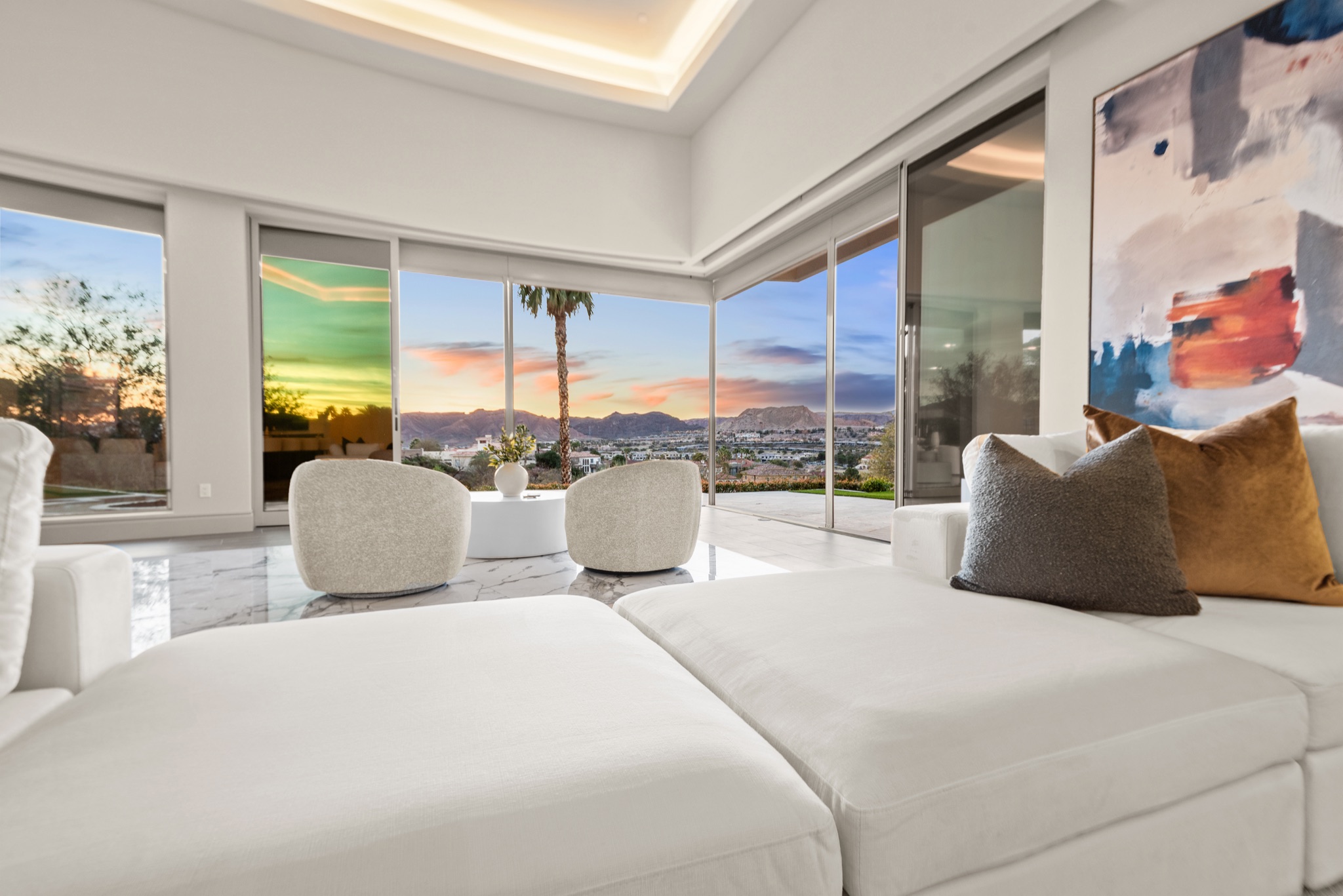 Luxury home staging Las Vegas $6.8M property with sunset views through curved glass wall