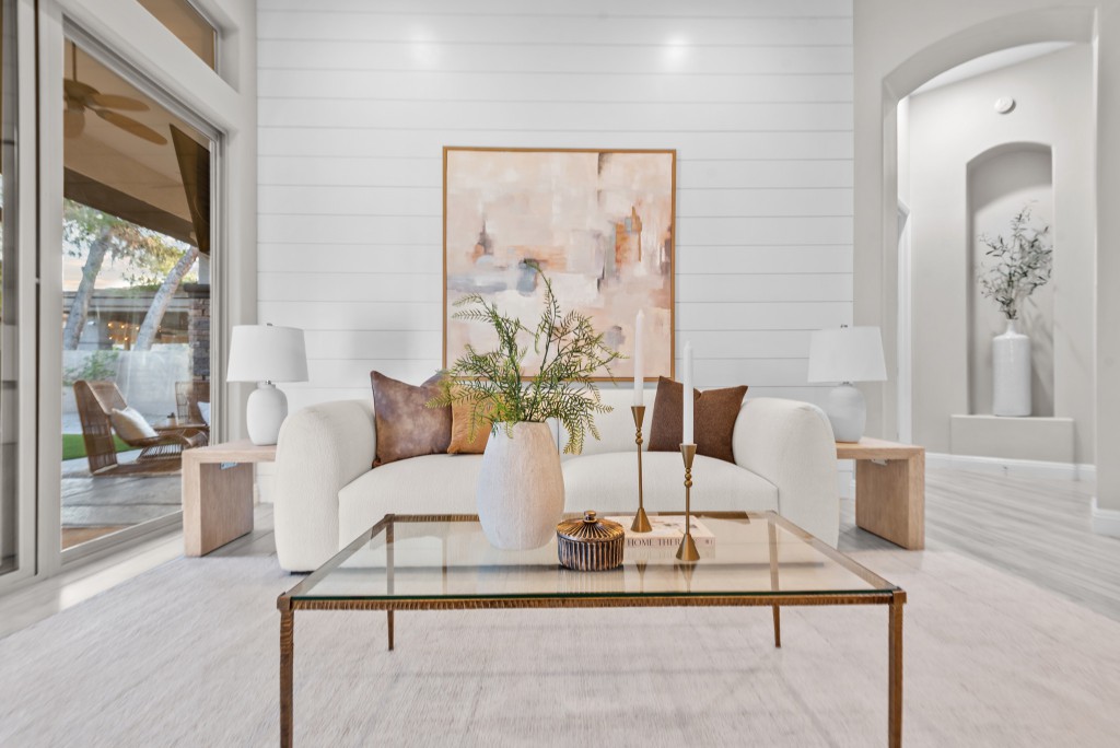 Luxury living room staged by Utopia Home Staging Las Vegas – cream sofa, shiplap accent wall, and brass accents in a staged Las Vegas home