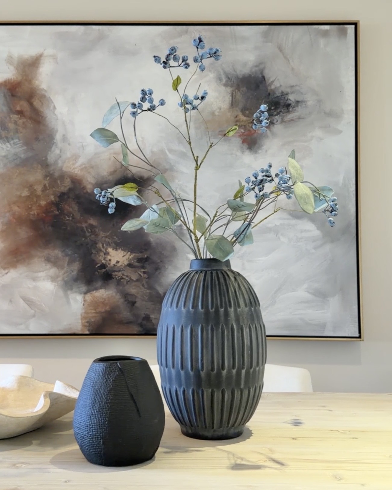 Curated staging vignette with ceramic vases and abstract art in a Las Vegas staged home